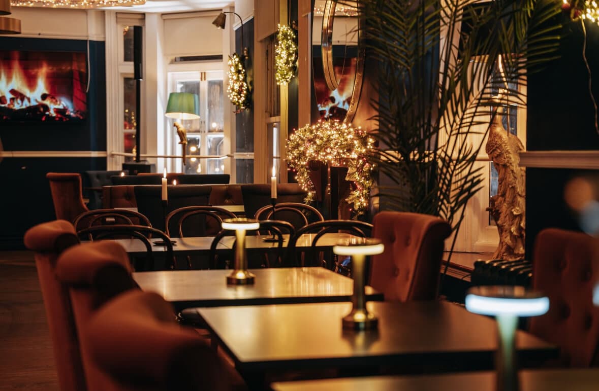 Clay Restaurant interior — candlelit tables, velvet chairs, warm amber light